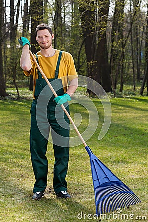 Man raking leaves in garden Stock Photo