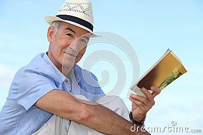 Man reading a book outside Stock Photo