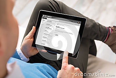 Man reading email on tablet Stock Photo