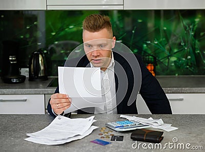 Man reading notice regarding late payments Stock Photo