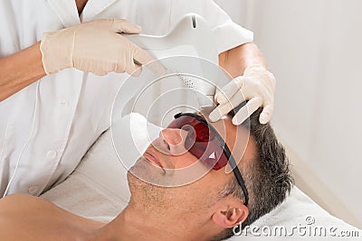 Man Receiving Laser Epilation Treatment Stock Photo