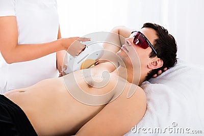 Man Receiving Laser Epilation Treatment On Underarms Stock Photo