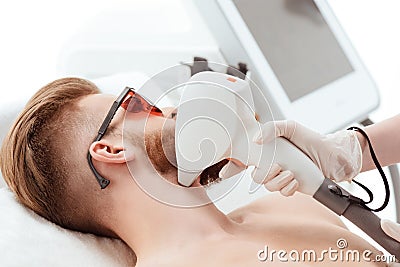 Man receiving laser skin care on face. healthy lifestyle man concept Stock Photo