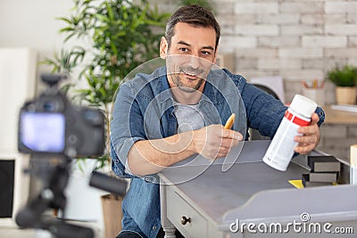 man recording blog showing product for furniture renovation Stock Photo