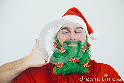 Man in red clothes with green beard show thumb up sign Stock Photo