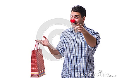 Man with a red nose funny holding a shopping bag gift present is Stock Photo