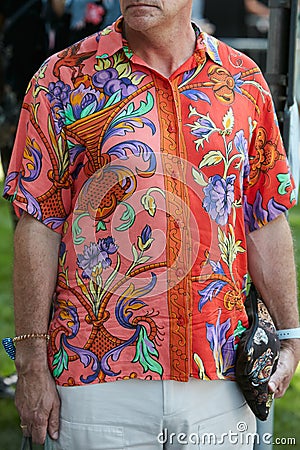 Man with red and orange shirt with floral design before Giorgio Armani fashion show, Milan Fashion Week street Editorial Stock Photo