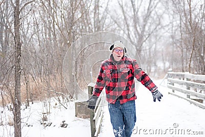 Man in plaid jacket having fun in the snow Stock Photo