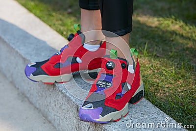 Man with red and purple insta pump Reebok shoes before Giorgio Armani fashion show, Milan Fashion Week street Editorial Stock Photo