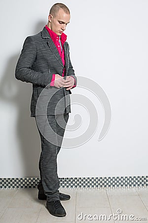 A man in a red shirt buttons fashion gray suit Stock Photo