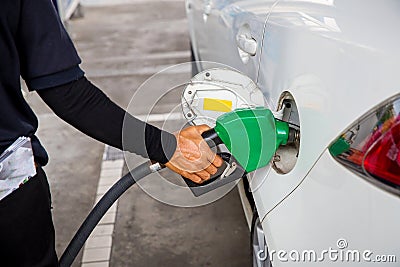 Man Refill and filling Oil Gas Fuel at station.Gas station - refueling. Stock Photo