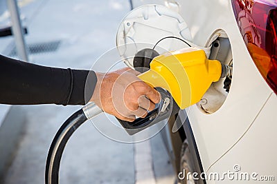 Man Refill and filling Oil Gas Fuel at station.Gas station - refueling. Stock Photo