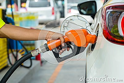 Man Refill and filling Oil Gas Fuel at station.Gas station - refueling.To fill the machine with fuel. Car fill with gasoline at a Stock Photo