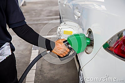 Man Refill and filling Oil Gas Fuel at station.Gas station - refueling.To fill the machine with fuel. Car fill with gasoline at a Stock Photo