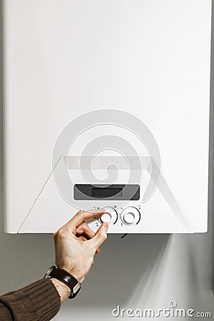 Man regulate power heating boiler control panel Stock Photo