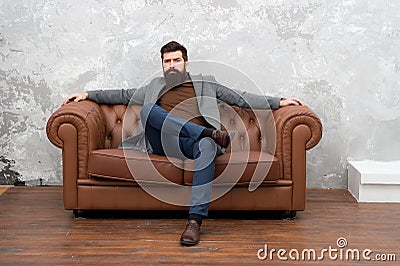 Man relaxing on luxurious leather couch, classic style concept Stock Photo