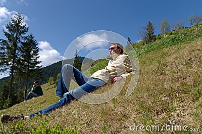 Man relaxing on a steep slope Stock Photo