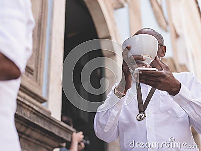 Man at the religious Mass of Santo Antonio de Categero in Rosario dos Pretos church in Salvador Editorial Stock Photo