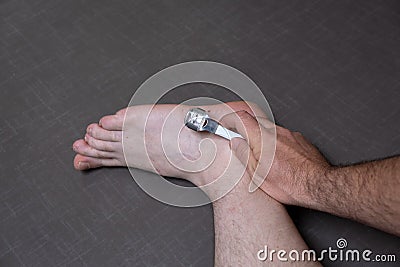 Man removing corn, callus from his feet using a razor file, masculine skin care, skin disease, fungal infection, skin Stock Photo
