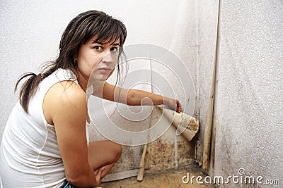 A girl removing Mold fungus without respirator mask Stock Photo