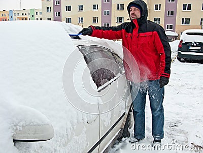 Man removing snow from car Stock Photo