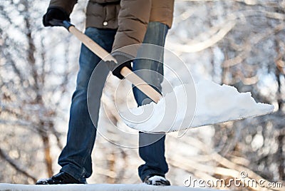 Man removing snow from a driveway Stock Photo