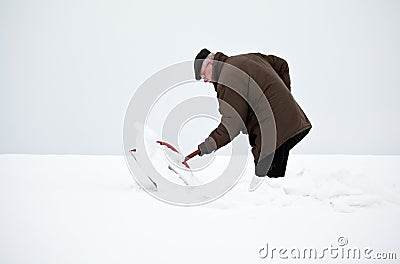 Man removing snow with a shovel Stock Photo