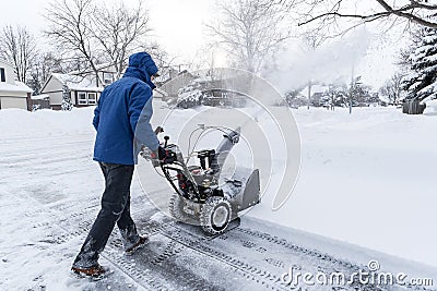 Man Removing Snow with a Snow Blower #1 Stock Photo