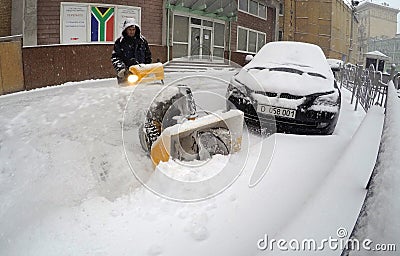 Man Removing Snow with a Snowblower Editorial Stock Photo