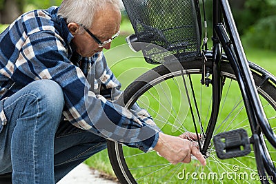 Man repairing bicycle wheel Stock Photo