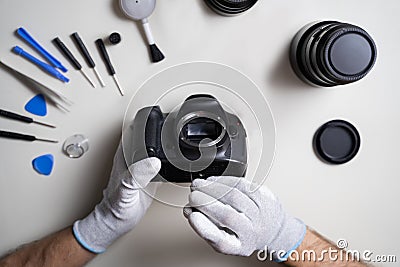 Man Repairing DSLR Camera Body Stock Photo