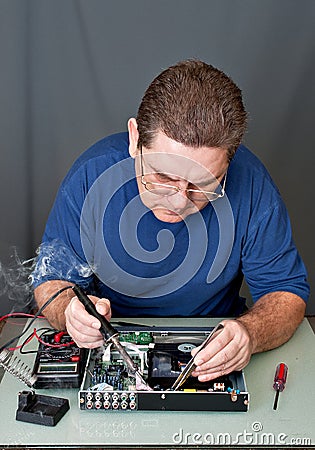 The man repairing DVD a player Stock Photo