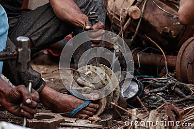 Man repairing mechanical waste stock image Stock Photo