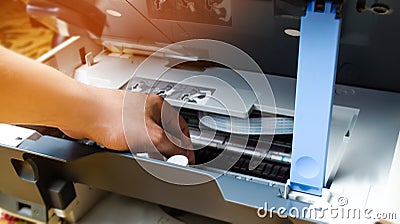 A man is repairing a printer. digital photocopier machine. printing equipment, 3d scanner Stock Photo
