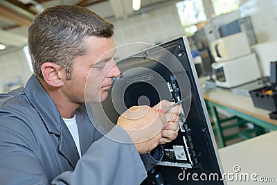 Man repairing screen Stock Photo