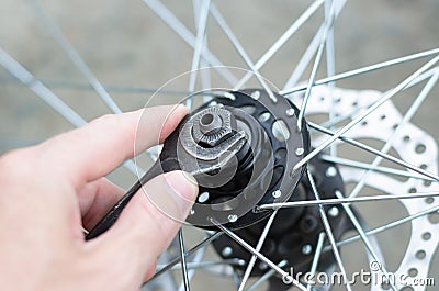 A man repairs a bicycle wheel. Stock Photo