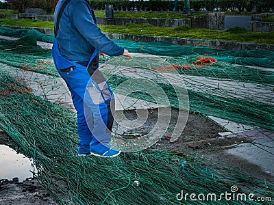Man reparing fishnet Stock Photo