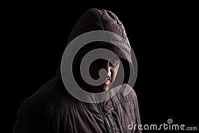 Man with repressed anger and violent instinct hiding in the shadows. Stock Photo