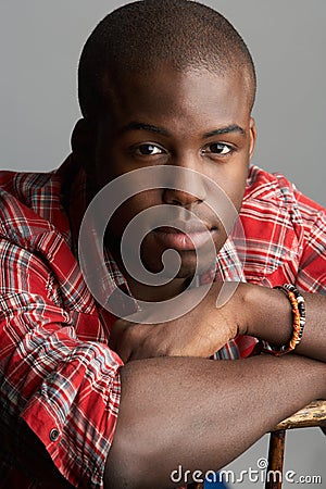 Man Resting On Chair In Studio Stock Photo