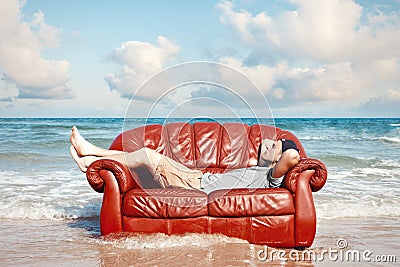 Man resting in leather couch Stock Photo