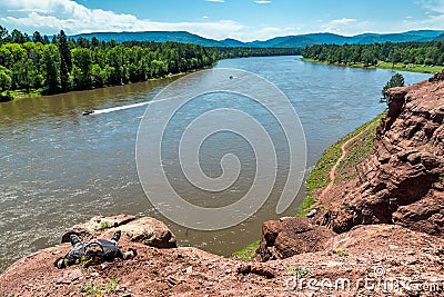 Man resting on rock above the river Irkut Stock Photo