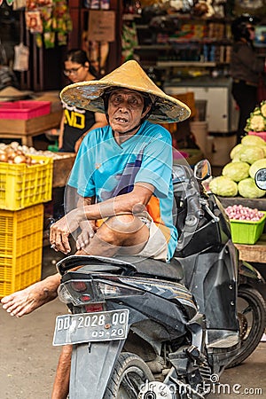 Man rests on motorbike at Terong Street Market in Makassar, South Sulawesi, Indonesia Editorial Stock Photo