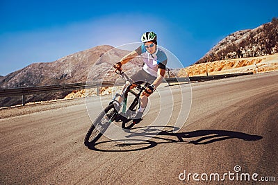 Man ride mountain bike on the road. Stock Photo