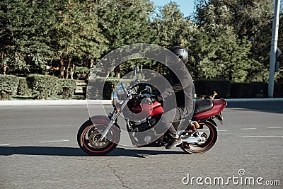 Man rides a motorcycle in the city.Motorcyclist riding a bike during the day on the road Stock Photo