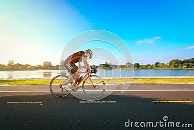 Man riding bicycle on the road and river side in the park. Stock Photo