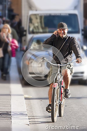 Man riding bicycle and talking on the phone Editorial Stock Photo