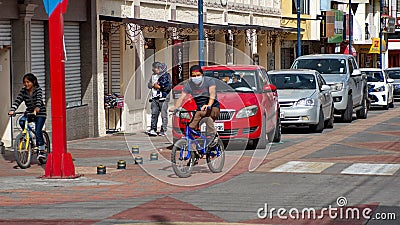 Man on a bicycle, wearing a mask Editorial Stock Photo