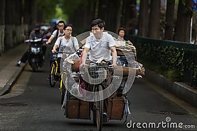 Man riding a bike to buy scrap Editorial Stock Photo