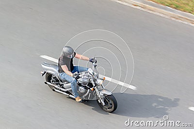 Man riding a chopper motorcycle with motion blur effect Editorial Stock Photo