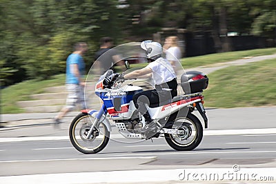 Man riding fast enduro motorbike on city street Editorial Stock Photo